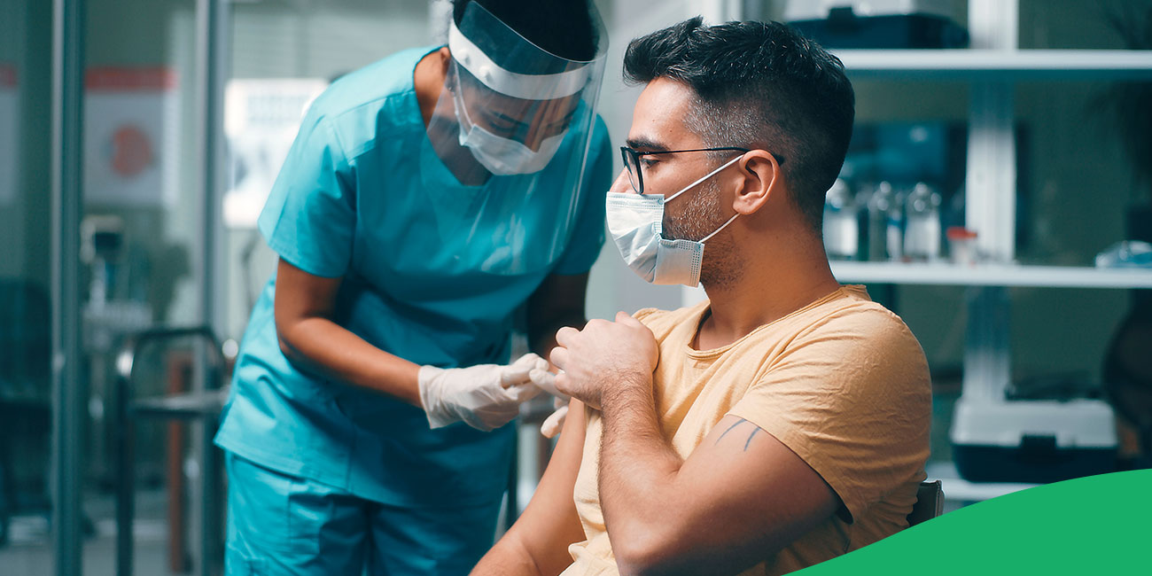 physician giving a shot to patient 