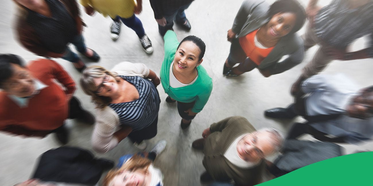 people looking upward and smiling