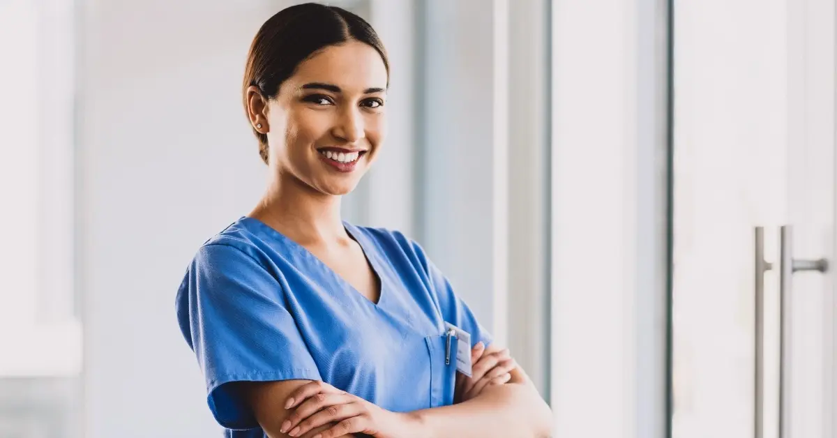 Closeup of a smiling onsite healthcare physician smiling with her arms crossed.