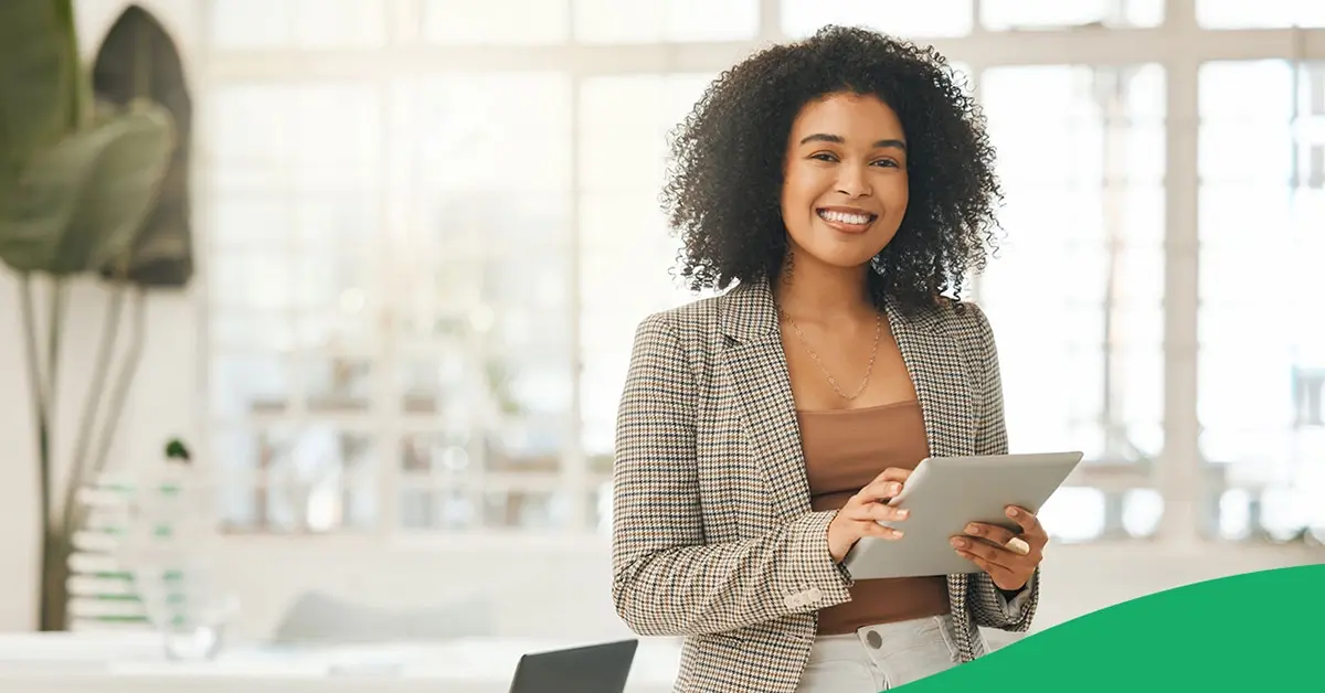 Smiling woman holding a tablet device.