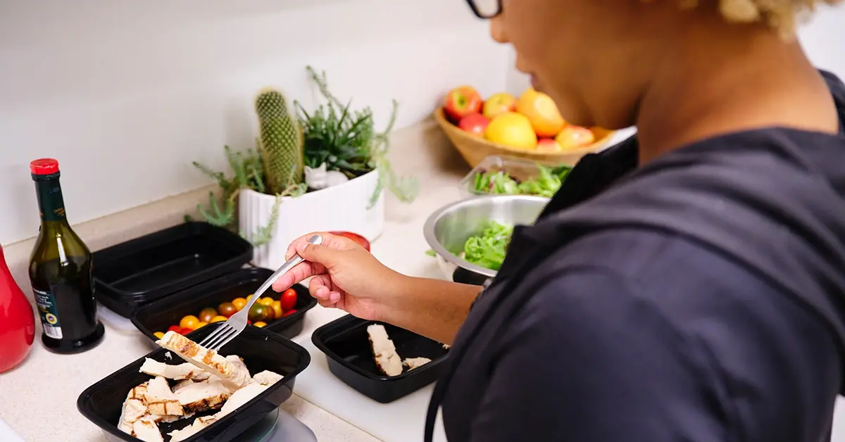 An employee eating a portion controlled meal as part of their weight management program.